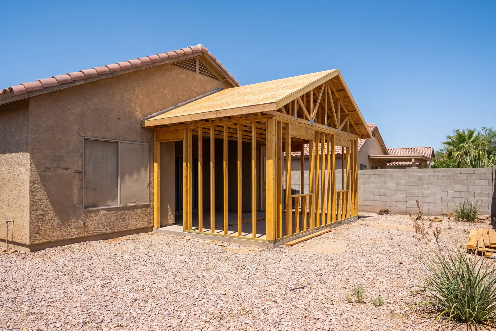 Room addition being framed onto an existing Arizona stucco home in the Valley, AZ