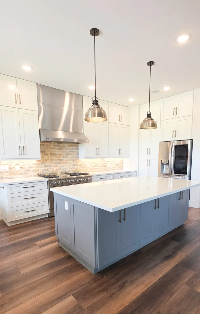 Two-tone kitchen with brick backsplash and stainless range hood, Valley AZ