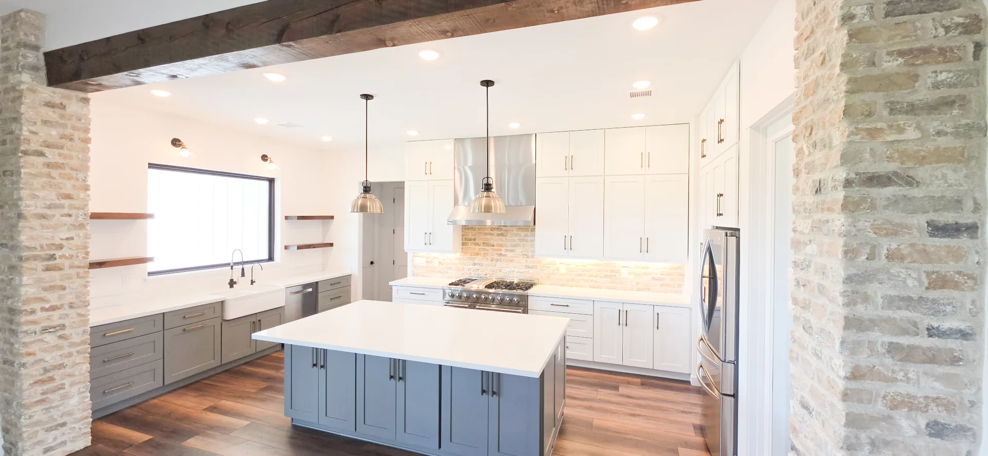 Full kitchen remodel with wood beam, brick accents and blue-gray island, Valley AZ