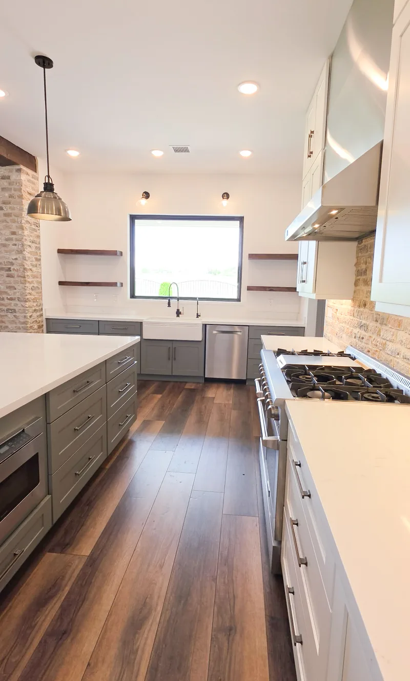 Open kitchen remodel with farmhouse sink and wide-plank wood floors, Valley AZ