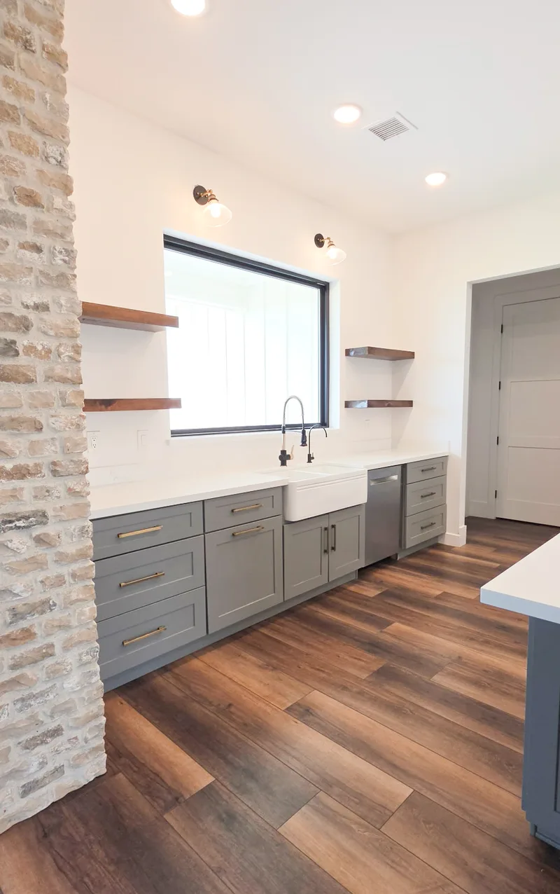 Kitchen sink wall with floating wood shelves and exposed brick, Valley AZ