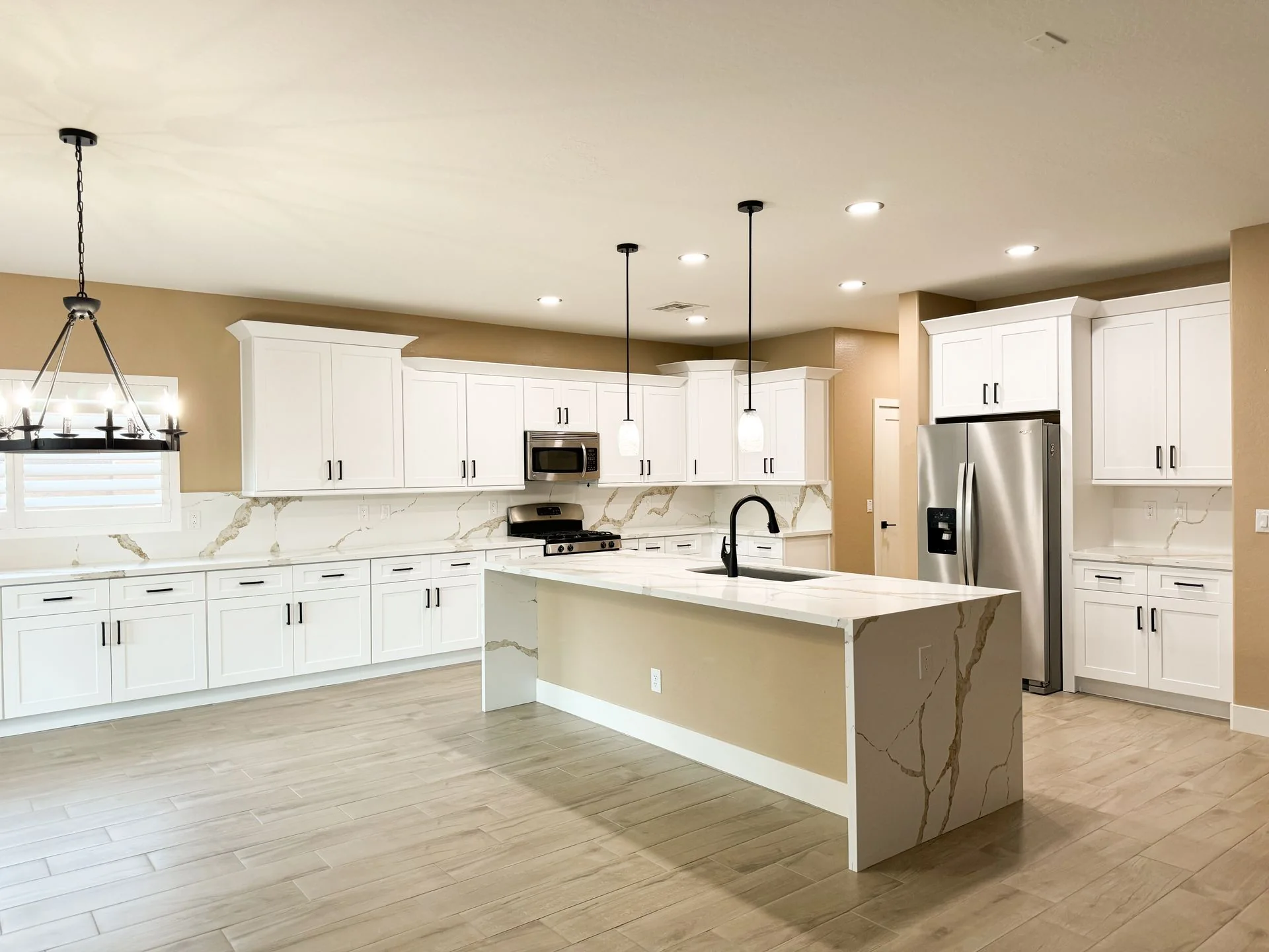 Luxury kitchen remodel with waterfall-edge quartz island and LED lighting in Surprise, AZ