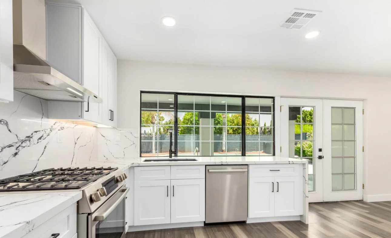Open-concept white kitchen with island seating, Valley AZ