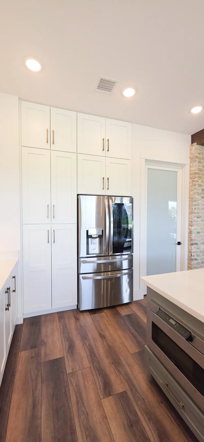 Floor-to-ceiling white pantry cabinets with French-door refrigerator, Valley AZ