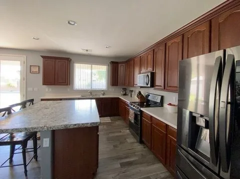 Spacious kitchen with wood cabinetry and stainless appliances, Valley AZ