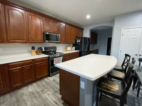 Wood cabinets paired with a white island, Glendale AZ